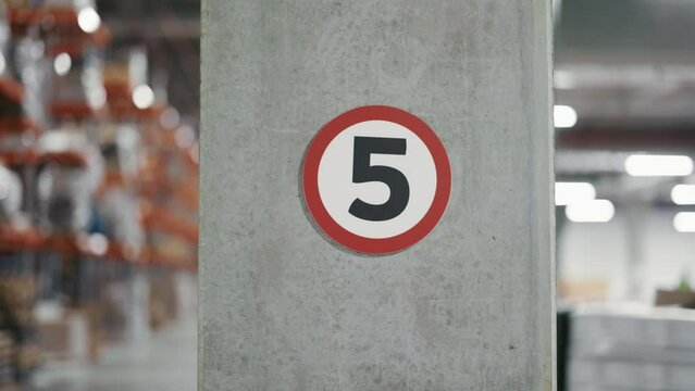 Speed Limit Sign in Warehouse: 5 km per Hour. Blurred Logistics Hub Background. Post Office in Facility. Warehouse, Logistic Center Concept