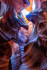 Beautiful vertical wide angle view of amazing sandstone formations in famous Antelope Canyon on a sunny day with blue sky near the old town of Page at Lake Powell, American Southwest, Arizona, USA