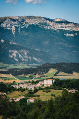 Fototapeta premium View on the Vercors Mountains range and the Glandasse mountain in the French Alps with a typical small village of Diois, Drôme