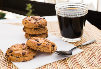 cookies with chocolate and hazelnuts and coffee are on table
