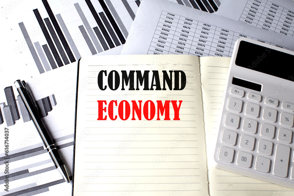 Poster command economy text written on a notebook on chart and diagram