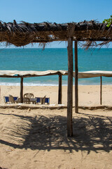 Beach's day. Seashore. Walk through the Caribbean Sea. Sand. Vacation. Roof built of palm