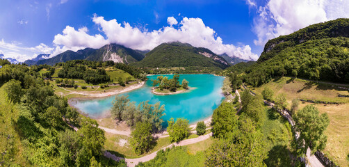 Amazing beautiful turquoise lake Tenno in Trentino region of Italy, surrouded by Alps mountains. Aerial drone panoramic view