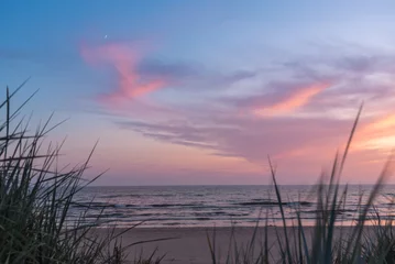 Tableau sur aluminium Paysages Summer evening after sunset on the Baltic sea beach with growing moon  © Julija