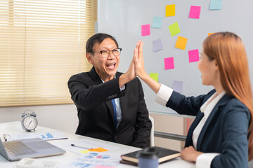Business partnership concept, Senior in business are giving high five gesture with partner