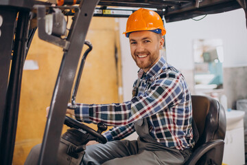 Man working at warehouse and driving forklift