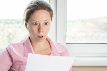 Woman's reaction to bills and fees in bank documents, shock and excitement upon reading an...