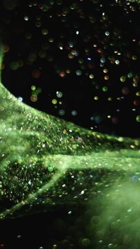 The small glitter particles flying in darkness. slow motion
