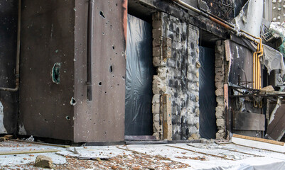 Residential buildings, windows and balconies were damaged by the blast and shrapnel from artillery shelling. The destruction of the city by military operations, the consequences of the war.