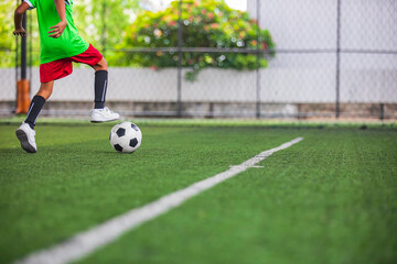 Obraz premium Soccer ball tactics children control the ball on a grass field for the training