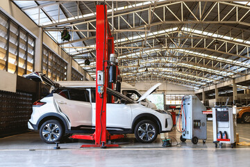 Fototapeta premium car in automobile repair service center with soft-focus and over light in the background