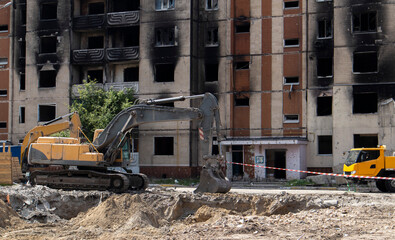 The process of demolition of the old dismantling of the building. The excavator breaks the house....