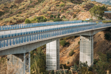 Modern highway bridge with striking architecture and sturdy supporting columns for efficient...