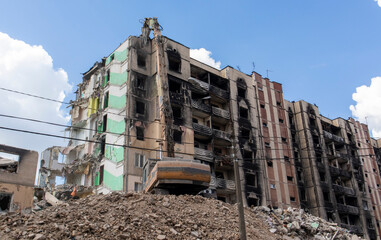 Excavator with hydraulic crusher at the demolition of a residential building. City renewal....