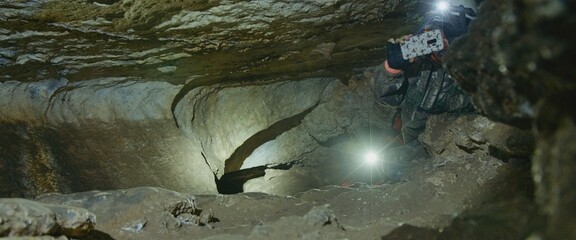 First person POV view captured danger tour. Walking in cave, fear set in. Holding the camera with...