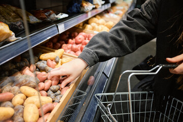 Hand Reaching for Fresh Produce at Supermarket
