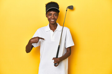 African golfer woman with her golf club, sports concept, person pointing by hand to a shirt copy...