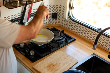 older man cooking in his motorhome,Aromas of Culinary Adventure