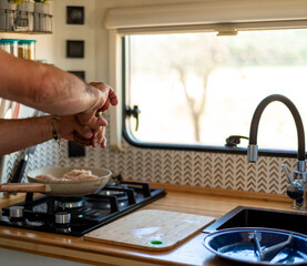 older man cooking in his motorhome,Cooking with Passion on the Road