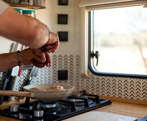 older man cooking in his motorhome,Flavor and Adventure on Every Plate