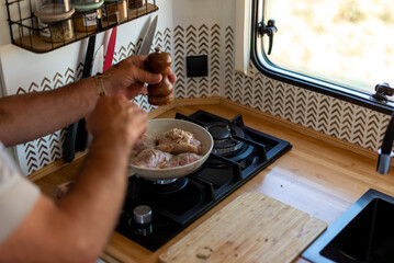 older man cooking in his motorhome,A Feast on Wheels