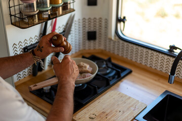 older man cooking in his motorhome,Mobile Kitchen in Action