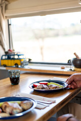 older man cooking in his motorhome,Culinary Delights Unveiled: An Elderly Chef Showcases His Masterpieces at the Motorhome Table