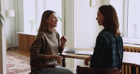 Young positive female office worker handshake colleague, express gratitude for help in project and teamwork, appreciate for advice, express recognition for good work, manager making deal with customer