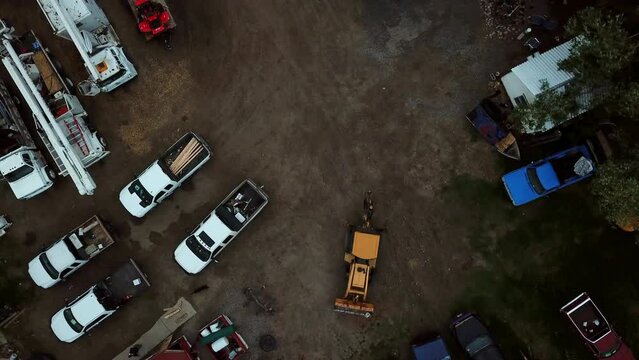Aerial Top View Of Vehicles With Dog On Dirt Road, Drone Descending Over Excavator - Billings, Montana
