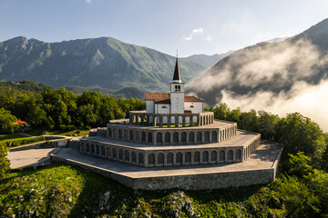 Drone view of St Anton Church and Kobarid Ossuary in Slovenia. Caporetto Memorial from First World...