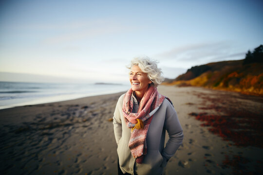 Mature woman in autumnal beach outdoors portrait