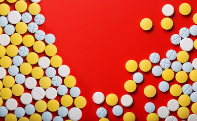 Medical pills . On red background. Top view .