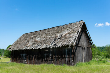 Fototapeta premium Old, abandoned wood barn near roadside in Romania in a small mountain settlement.