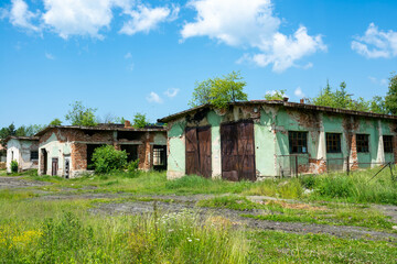 Fototapeta na wymiar Abandoned brick warehouse buildings in a small mountain settlement in Romania.