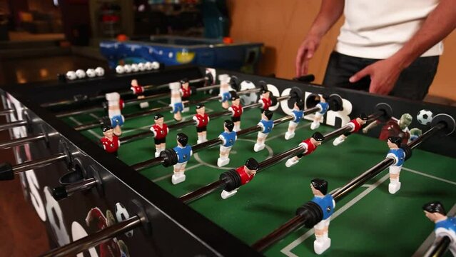 People play table football in a cafe. Close-up