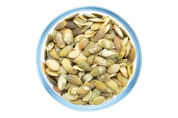 Peeled pumpkin seeds in a bowl, top view. Isolated on white background.