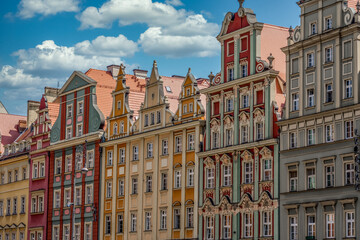 Fototapeta premium Wroclaw Market Square, lined with colorful elegant townhouses cloudy blue summer sky