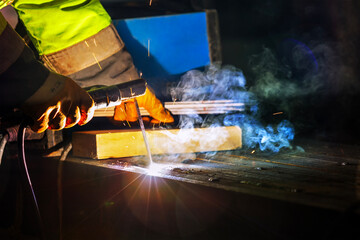 Welder is welding with shielded metal arc welding process to steel materials. Shielded metal arc...