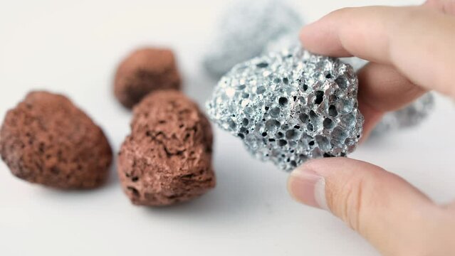 Geologists hold platinum or silver, copper, and rare earth minerals found in mines for examination and consideration in the lab.