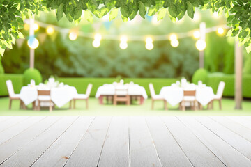 Empty wooden table with party in garden background blurred.