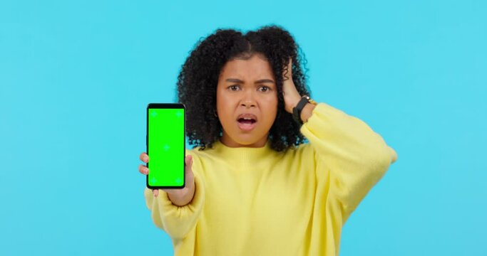 Woman, green screen phone and angry in studio with error, 404 glitch and mock up space by blue background. African student girl, smartphone or stress for slow internet, software update or fail on app