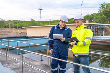 Environmental engineers work at wastewater treatment plants,Water supply engineering working at Water recycling plant for reuse,Technicians and engineers discuss work together.
