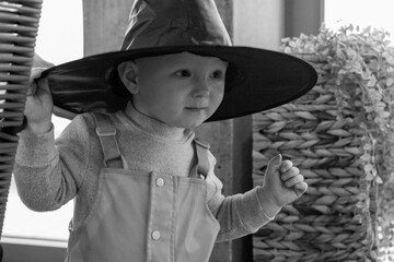 baby boy 1 year old in a pointed hat for halloween gnome costume handsome kid