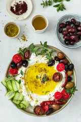 Popular middle eastern appetizer labneh .Cream cheese dip with olive oil, Cherry tomatoes,cucumber, herbs and olives