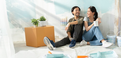 New home,Repair,happy,New life,insurance,carefree relationship,love lifestyle,new apartment,renovation and decorating concept.Young asian couple choosing blue color.happy smiling asian couple in home