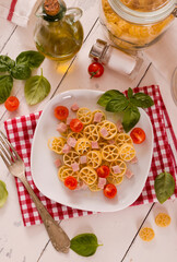 Ruote pasta with tomato and ham. - 616769049