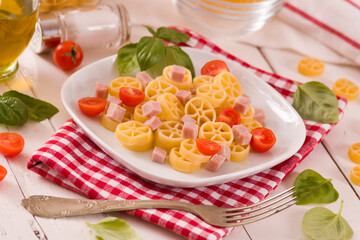 Ruote pasta with tomato and ham.