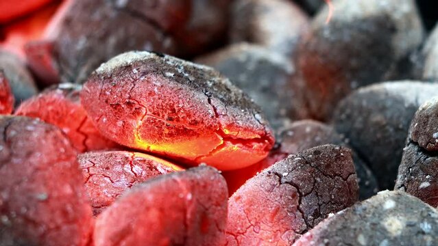 Glowing Charcoal Briquettes, BBQ oder close up of coals burning
