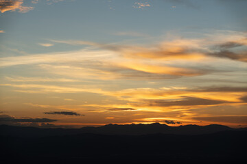 Road bike parked on a beautiful road sunset, warm light with copy space.	