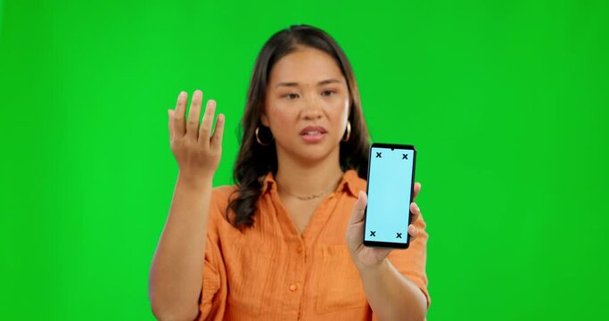 Frustrated asian woman, phone and mockup on green screen in fail or confused against a studio background. Portrait of annoyed female person with mobile smartphone mock up display and tracking markers